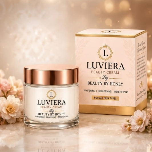 Luviera Beauty Cream jar and matching product box on a warm beige background with decorative flowers and glowing bokeh light effects. Text at the top reads 'LUVIERA BEAUTY CREAM By BEAUTY BY HONEY'.